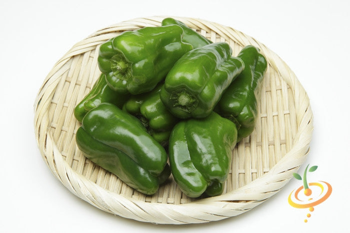 Fresh green Ancho Grande hot peppers on a woven basket