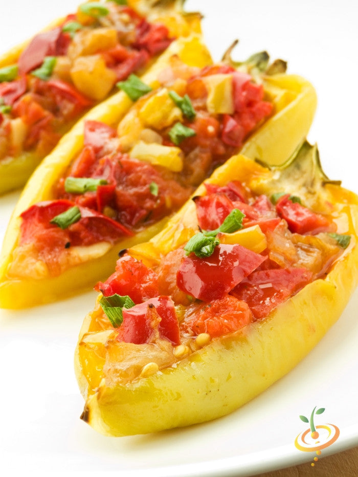Stuffed Hungarian Hot Wax peppers with diced red and yellow fillings garnished with chopped green herbs on white plate