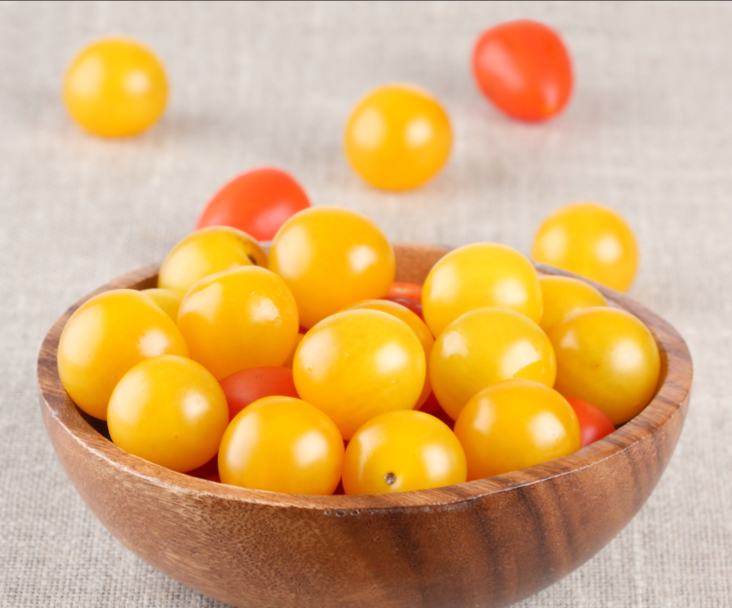 Indeterminate Egg Tomato seeds from SeedsNow, featuring vibrant green egg-shaped tomatoes on healthy plants.